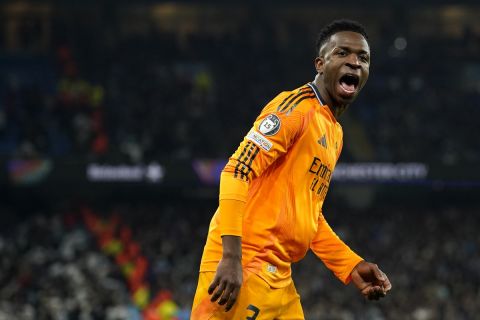 Real Madrid's Vinicius Junior celebrates after his teammate Real Madrid's Brahim Diaz scored their side second goal during the Champions League playoff first leg soccer match between Manchester City and Real Madrid at the Etihad Stadium in Manchester, England, Tuesday, Feb. 11, 2025. (AP Photo/Dave Thompson)