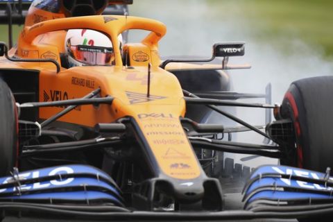 Mclaren driver Lando Norris of Britain steers his car during the second practice session for the British Formula One Grand Prix at the Silverstone circuit in Silverstone, England, Friday, July 31, 2020. The British Formula One Grand Prix race will be held on Sunday. (Bryn Lennon/Pool via AP)