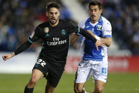 Real Madrid's Francisco Roman Isco, left, vies for the ball with Leganes' Gabriel Appelt during a Spanish La Liga soccer match between Real Madrid and Leganes at the Butarque stadium in Leganes, outside Madrid, Wednesday, Feb. 21, 2018. (AP Photo/Francisco Seco)