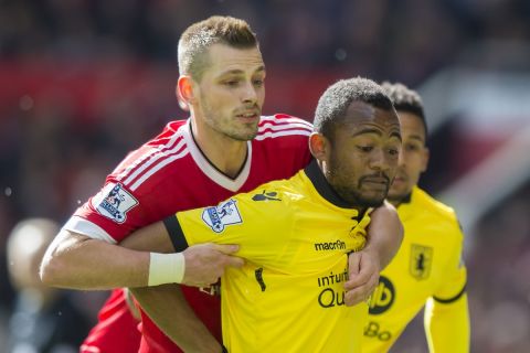 Manchester United's Morgan Schneiderlin, left, challenges Aston Villa's Jordan Ayew for the ball during the English Premier League soccer match between Manchester United and Aston Villa at Old Trafford Stadium, Manchester, England, Saturday, April 16, 2016. (AP Photo/Jon Super)