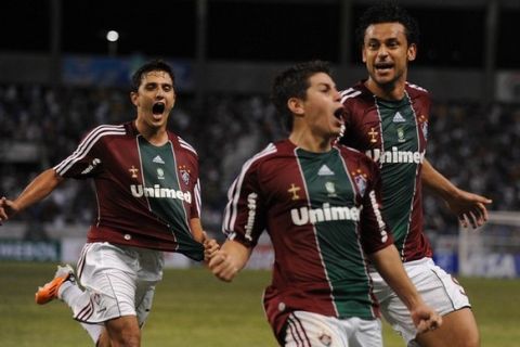 Brazil's Fluminense Dario Conca (C) celebrates with teammates Fred (L) and Marquinhos his goal against Paraguay's Libertad  Club during their Copa Libertadores  football match at Joao Havelange Olympic stadium in Rio de Janeiro, Brazil, on April 28, 2011. AFP PHOTO /VANDERLEI ALMEIDA (Photo credit should read VANDERLEI ALMEIDA/AFP/Getty Images)