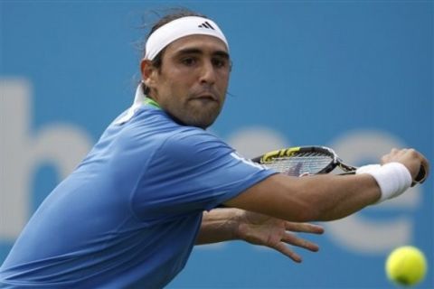 Marcos Baghdatis of Cyprus returns against Arnaud Clement of France in the men's singles Unicef Open tennis tournament in Rosmalen, central Netherlands Monday June 13, 2011. (AP Photo/Peter Dejong)