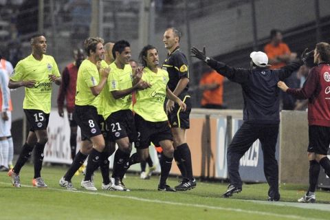 Stade Malherbe de Caen's Nicolas Seube (C) celebrates with teamates after scoring a goal during the French L1 football match Marseille versus Caen at the Velodrome stadium in Marseille, southern France on August 7, 2010. AFP PHOTO / BERTRAND LANGLOIS (Photo credit should read BERTRAND LANGLOIS/AFP/Getty Images)