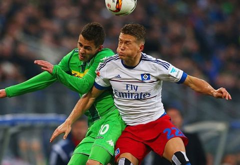 HAMBURG, GERMANY - FEBRUARY 14:  Matthias Ostrzolek of SV Hamburg and Thorgan Hazard of Borussia Moenchengladbach jump for the ball during the Bundesliga match between Hamburger SV and Borussia Moenchengladbach at Volksparkstadion on February 14, 2016 in Hamburg, Germany.  (Photo by Martin Rose/Bongarts/Getty Images)