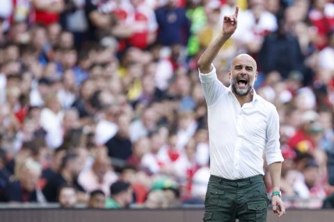 Manchester City's manager Pep Guardiola gives instructions to his players during the English FA Community Shield final soccer match between Arsenal and Manchester City at Wembley Stadium in London, Sunday, Aug. 6, 2023. (AP Photo/David Cliff)