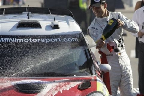 Daniel Sordo Corral of Spain, sprays champagne over his Mini John Cooper Works after taking the second place in the Rally of France in Strasbourg, eastern France, Sunday, Oct. 2, 2011. Sebastien Loeb of France and Daniel Elena of Monaco driving their Citroen DS3 WRC  won the Rally of France. (AP Photo/Lionel Cironneau)