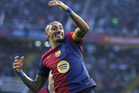 Barcelona's Raphinha celebrates after scoring his side's second goal during a Spanish La Liga soccer match between Barcelona and Espanyol at the Lluis Companys Olympic Stadium in Barcelona, Spain, Sunday, Nov. 3, 2024. (AP Photo/Joan Monfort)