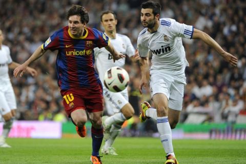 Barcelona's Argentinian forward Lionel Messi (L) vies with Real Madrid's defender Raul Albiol (R) during "El Clasico" Spanish League football match Real Madrid against Barcelona at the Santiago Bernabeu stadium in Madrid, on April 16, 2011. AFP PHOTO/JAVIER SORIANO (Photo credit should read JAVIER SORIANO/AFP/Getty Images)