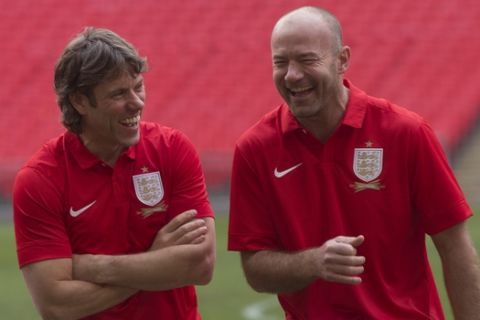 British comedian John Bishop, left, jokes with former premier soccer player Alan Shearer ahead of the celebrity soccer match between Nick Grimshaw's team Radio One-derers and Olly Murs' team Tottenham Hot-murs, at Wembley Stadium in London, Tuesday, Dec. 10, 2013. (Photo by Joel Ryan/Invision/AP)