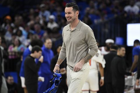 Former Orlando Magic guard JJ Redick, center, leaves the court after being honored by the team during the first half of an NBA basketball game against the New York Knicks, Wednesday, Feb. 14, 2024, in Orlando, Fla. (AP Photo/Phelan M. Ebenhack)
