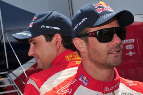 French driver Sebastien Loeb (R) stands near his Citroen DS3 WRC during the shakedown stage of the WRC Italian auto rally 2011 on May 5, 2011 in Olbia, Sardinia.  Sebastien Loeb and team mate Sebastien Ogier will be going head to head with their Ford rivals Mikko Hirvonen and Jari-Matti Latvala, in a race starting on May 6  which will also include Minis, driven by Dani Sordo and Kris Meeke.  AFP PHOTO / GIUSEPPE CACACE (Photo credit should read GIUSEPPE CACACE/AFP/Getty Images)