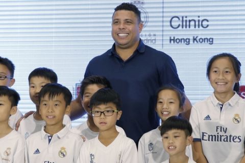 Brazilian football star Ronaldo Luis Nazario, center, poses with his fans during a promotional event for the Real Madrid Foundation Clinics in Hong Kong, Saturday, May 27, 2017. (AP Photo/Kin Cheung)