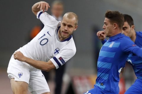 Finland's Teemu Pukki, left, passes the ball as Greece's Leonardo Kourtis, center and Sokratis Papastathopoulos try to stop him during the UEFA Nations League soccer match between Greece and Finland at Olympic stadium in Athens, Thursday, Nov. 15, 2018. (AP Photo/Thanassis Stavrakis)