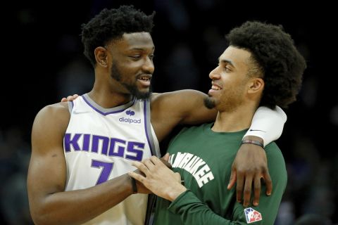 Sacramento Kings forward Chimezie Metu (7) talks with Milwaukee Bucks forward Jordan Nwora (13) after an NBA basketball game Saturday, Jan. 22, 2022, in Milwaukee. The Bucks won 133-127. (AP Photo/Jon Durr)