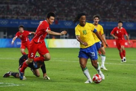 QINHUANGDAO, CHINA - AUGUST 13:  Ronaldhino of Brazil pressed by Li Weifeng of China during the men's preliminary group C match between China and Brazil at the Quinhuangdao Olympic Center Stadium on Day 5 of the Beijing 2008 Olympic Games on August 13, 2008 in Qinhuangdao, China.  (Photo by Michael Steele/Getty Images)