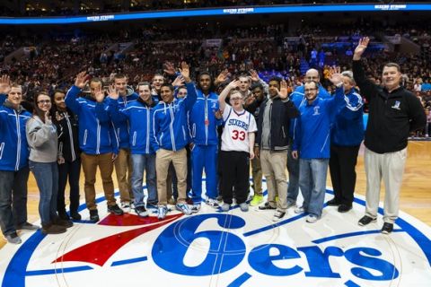 Feb 18, 2014; Philadelphia, PA, USA; Bensalem High School student Kevin Grow  poses for photos with members of his basketball team at half court during the second quarter of a game between the Philadelphia 76ers and the Cleveland Cavaliers  at the Wells Fargo Center. Mandatory Credit: Howard Smith-USA TODAY Sports ORG XMIT: USATSI-141062 ORIG FILE ID:  20140218_hcs_sy4_021.jpg
