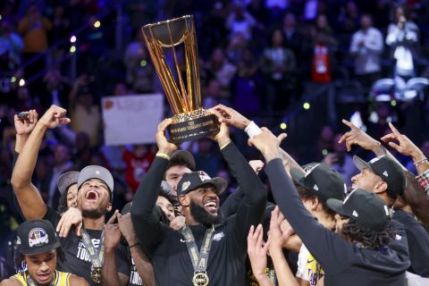 Los Angeles Lakers forward LeBron James, center, lifts the the NBA Cup while celebrating with teammates after they defeated the Indiana Pacers 123-109 in the championship game in the NBA basketball In-Season Tournament on Saturday, Dec. 9, 2023, in Las Vegas.(AP Photo/Ian Maule)