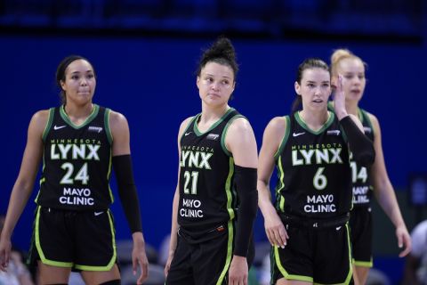 Minnesota Lynx's Napheesa Collier (24), Kayla McBride (21), Bridget Carleton (6) and Dorka Juhasz, right, stands on the quart late in the second half of a WNBA basketball game against the Dallas Wings in Arlington, Texas, Thursday, June 27, 2024. (AP Photo/Tony Gutierrez)