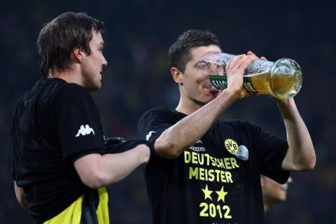 DORTMUND, GERMANY - APRIL 21: (L-R) Kevin Grosskreutz and Robert Lewandowski of Dortmund celebrate after winning the German Championships after winning 2-0 the 1. Bundesliga match between Borussia Dortmund an Borussia Moenchengladbach at Signal Iduna Park on April 21, 2012 in Dortmund, Germany.  (Photo by Christof Koepsel/Bongarts/Getty Images)