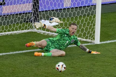 England's goalkeeper Jordan Pickford saves a penalty during the penalty shootout of the quarterfinal match between England and Switzerland at the Euro 2024 soccer tournament in Duesseldorf, Germany, Saturday, July 6, 2024. (AP Photo/Andreea Alexandru)