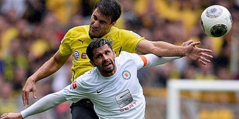 DORTMUND, GERMANY - AUGUST 18:  Sokratis of Borussia Dortmund challenges Dennis Kruppke of Eintracht Braunschweig during the Bundesliga match between Borussia Dortmund and Eintracht Braunschweig at Signal Iduna Park on August 18, 2013 in Dortmund, Germany.  (Photo by Dennis Grombkowski/Bongarts/Getty Images)