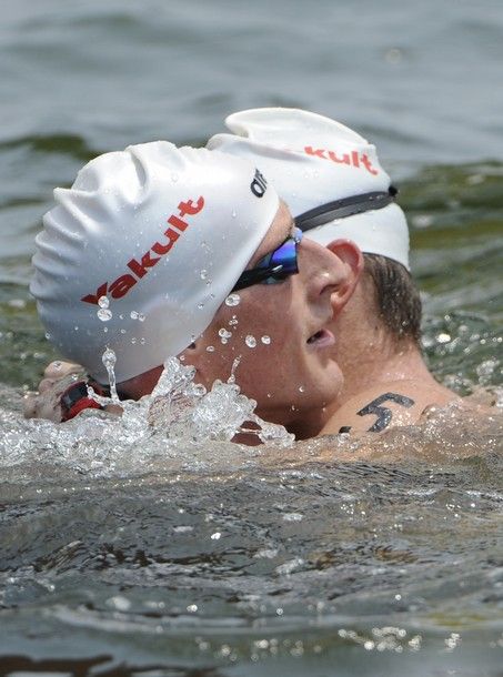 Gold medal winner Germany's Thomas Lurz (L) is congratulated by silver medal winner Greece's Spyros Gianniotis after crossing the finish line in the men's 5km open water swimming event of the FINA World Championships at Jinshan beach in Shanghai on July 22, 2011. AFP PHOTO / PHILIPPE LOPEZ (Photo credit should read PHILIPPE LOPEZ/AFP/Getty Images)