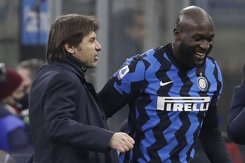 Inter Milan's head coach Antonio Conte congratulates his player Romelu Lukaku who scores the two goals during a Serie A soccer match between Inter Milan and Lazio at the San Siro stadium in Milan, Italy, Sunday, Feb. 14, 2021. (AP Photo/Luca Bruno)