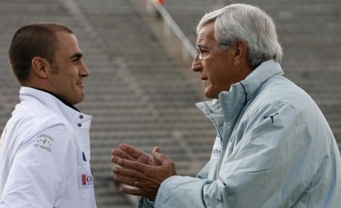 Italian soccer team captain Fabio Cannavaro  (L) talks to coach Marcello Lippi (R), before a practice game against a local invitational team at Atteridgeville township near Pretoria, June 12. Italy were preparing ahead of the FIFA Confederations Cup 2009, which kicks off on June 14. REUTERS/Mike Hutchings (SOUTH AFRICA SPORT SOCCER)