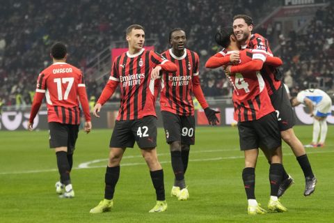 AC Milan's Davide Calabria, right, celebrates with teammates after scoring during the Italian Cup eight final soccer match between AC Milan and Sassuolo at the San Siro stadium in Milan, Italy, Tuesday, Dec. 3, 2024. (AP Photo/Luca Bruno)