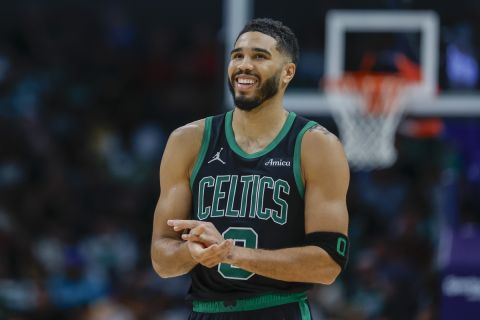 Boston Celtics forward Jayson Tatum smiles during the second half of an NBA basketball game against the Charlotte Hornets in Charlotte, N.C., Friday, Nov. 1, 2024. (AP Photo/Nell Redmond)