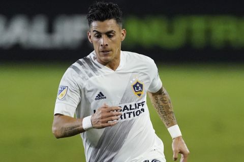 LA Galaxy forward Cristian Pavon runs with the ball during the first half of an MLS soccer match Wednesday, Nov. 4, 2020, in Carson, Calif. (AP Photo/Ashley Landis)