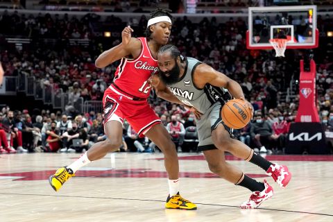 RETRANSMISSION TO REMOVE SCORE - Brooklyn Nets' James Harden, right, drives on Chicago Bulls' Ayo Dosunmu during the first half of an NBA basketball game Wednesday, Jan. 12, 2022, in Chicago. (AP Photo/Charles Rex Arbogast)