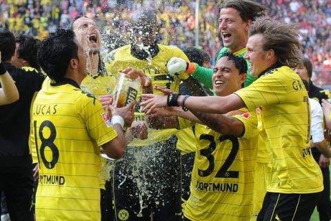 RESTRICTIONS / EMBARGO - ONLINE CLIENTS MAY USE UP TO SIX IMAGES DURING EACH MATCH WITHOUT THE AUTHORISATION OF THE DFL. NO MOBILE USE DURING THE MATCH AND FOR A FURTHER TWO HOURS AFTERWARDS IS PERMITTED WITHOUT THE AUTHORISATION OF THE DFL.Dortmund's Argentinian striker Lucas Barrios (L) and his teammates celebrate after the German first division Bundesliga football match between Borussia Dortmund and 1.FC Nuremberg, in Dortmund, on April 30, 2011. Borussia Dortmund were crowned Bundesliga champions with a 2-0 win at home against Nuremberg, landing their first German league title since 2002.     AFP PHOTO / PATRIK STOLLARZ (Photo credit should read PATRIK STOLLARZ/AFP/Getty Images)