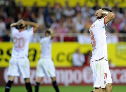 Sevilla's Argentinian midfielder Emiliano Armenteros (R), midfielder Jesus Navas (center) and forward Manu del Moral (L) react during a Spanish Liga football match against Granada, on October 31, 2011 at Ramon Sanchez Pizjuan stadium in Sevilla.The match ended 1-2.AFP PHOTO / CRISTINA QUICLER (Photo credit should read CRISTINA QUICLER/AFP/Getty Images)