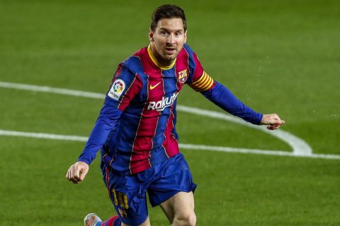 Barcelona's Lionel Messi celebrates after scoring the opening goal during the Spanish La Liga soccer match between FC Barcelona and Getafe at the Camp Nou stadium in Barcelona, Spain, Thursday, April 22, 2021. (AP Photo/Joan Monfort)