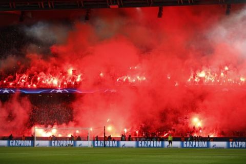 PSG's fans hold flares during the round of 16, 2nd leg Champions League soccer match between Paris Saint-Germain and Real Madrid at the Parc des Princes Stadium in Paris, Tuesday, March 6, 2018. (AP Photo/Francois Mori)