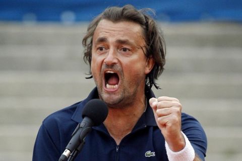 Former French tennis ace Henri Leconte jokes while sitting on the referee's chair during a show match against former tennis player Michael Stich from Germany during their show match at the ATP BMW Open tennis tournament in Munich, southern Germany, on Thursday, May 3, 2007. (AP Photo/Christof Stache)