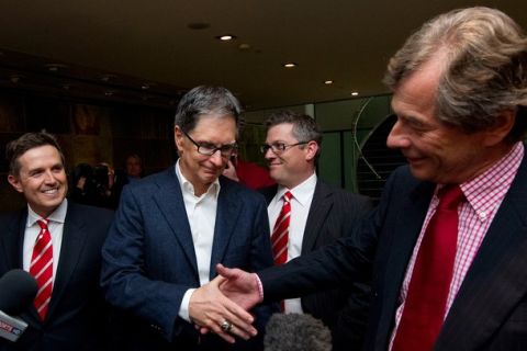 Owner of the Boston Red Sox baseball team, and new owner of Liverpool Football Club, John W. Henry (2nd L) , shakes hands with club's Chairman, Martin Broughton (R), as they address the media, after a meeting with lawyers, in central London on October 15, 2010.       New England Sports Ventures (NESV), owners of baseball's Boston Red Sox, completed their acrimonious 300 million pounds (480 million dollars) takeover of Liverpool football club on Friday.     AFP PHOTO / Carl Court (Photo credit should read Carl Court/AFP/Getty Images)