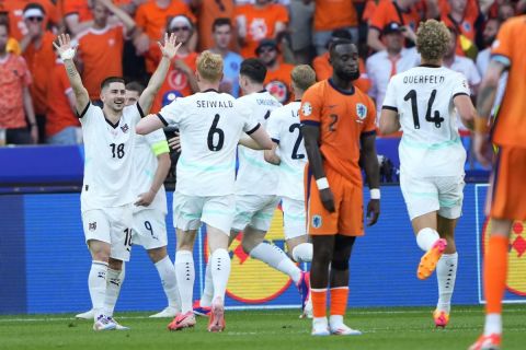 Austria players celebrate the third goal from they teammate Marcel Sabitzer after scoring against Netherlands during a Group D match between Netherlands and Austria at the Euro 2024 soccer tournament in Berlin, Germany, Tuesday, June 25, 2024. (AP Photo/Ebrahim Noroozi)