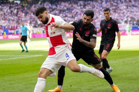 Croatia's Josko Gvardiol, left, fights for the ball with Albania's Elseid Hysaj during a Group B match between Croatia and Albania at the Euro 2024 soccer tournament in Hamburg, Germany, Wednesday, June 19, 2024. (AP Photo/Ebrahim Noroozi)