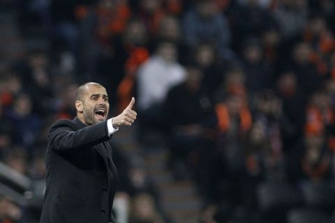 Barcelona's coach Josep Guardiola reacts during the second leg of his teams Champions League quarter-final soccer match against Shakhtar Donetsk at the Donbass Arena in Donetsk April 12, 2011.  REUTERS/Gleb Garanich (UKRAINE - Tags: SPORT SOCCER)