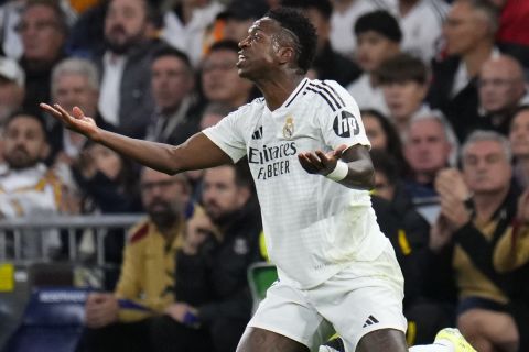 Real Madrid's Vinicius Junior reacts during a Spanish La Liga soccer match between Real Madrid and Barcelona at the Santiago Bernabeu stadium in Madrid, Spain, Saturday, Oct. 26, 2024. (AP Photo/Manu Fernandez)