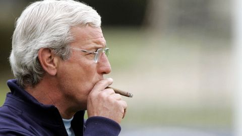 Italy's National soccer team coach Marcello Lippi, smokes during a training session in Coverciano, Italy, Wednesday, March 23, 2005. Italy will play next Saturday against Scotland for a Germany 2006 Soccer World Cup qualifier match. (AP Photo/Fabrizio Giovannozzi)