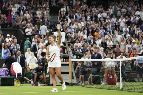 Jasmine Paolini of Italy celebrates after defeating Emma Navarro of the United States in their quarterfinal match at the Wimbledon tennis championships in London, Tuesday, July 9, 2024. (AP Photo/Alberto Pezzali)