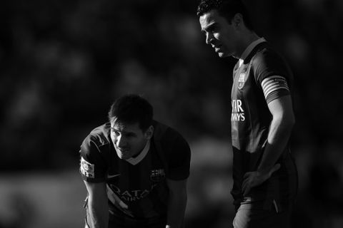 VALLADOLID, SPAIN - MARCH 08:   (Editors Note. Image converted to B&W. Colour version available) Lionel Messi (L) of FC Barcelona lines up a free kick with Xavi Hernandez during the La Liga match between Real Valladolid CF and FC Barcelona at estadio Nuevo Jose Zorillo on March 8, 2014 in Valladolid, Spain.  (Photo by Denis Doyle/Getty Images)