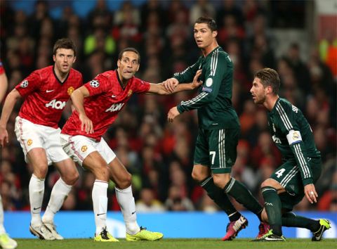 MANCHESTER, ENGLAND - MARCH 05:  Rio Ferdinand of Manchester United in action with Cristiano Ronaldo of Real Madrid during the UEFA Champions League Round of 16 second leg match between Manchester United and Real Madrid at Old Trafford on March 5, 2013 in Manchester, United Kingdom.  (Photo by John Peters/Man Utd via Getty Images)