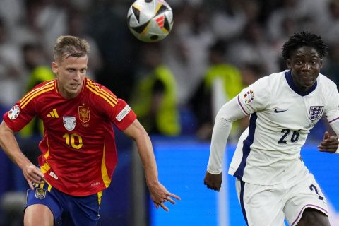 England's Kobbie Mainoo vies for the ball with Spain's Dani Olmo, left, during the final match between Spain and England at the Euro 2024 soccer tournament in Berlin, Germany, Sunday, July 14, 2024. (AP Photo/Manu Fernandez)