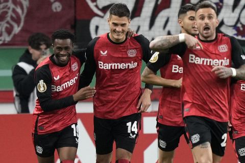 Leverkusen's Patrik Schick, center, celebrates after scoring the opening goal during the German Soccer Cup match between Bayer Leverkusen and SV Elversberg at the BayArena in Leverkusen, Germany, Tuesday, Oct. 29, 2024. (AP Photo/Martin Meissner)