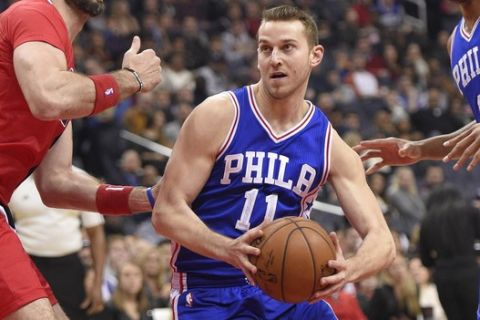 Philadelphia 76ers guard Nik Stauskas (11) drives to the basket against Washington Wizards center Marcin Gortat (13), of Poland, during the first half of an NBA basketball game, Saturday, Jan. 14, 2017, in Washington. (AP Photo/Nick Wass)