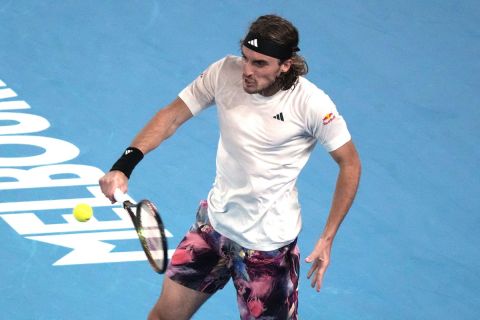 Stefanos Tsitsipas of Greece plays a backhand return to Rinky Hijikata of Australia during their second round match at the Australian Open tennis championship in Melbourne, Australia, Wednesday, Jan. 18, 2023. (AP Photo/Dita Alangkara)